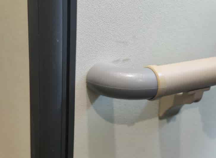 A door handle with a handle attached to it, featuring PVC wall guards for added protection.