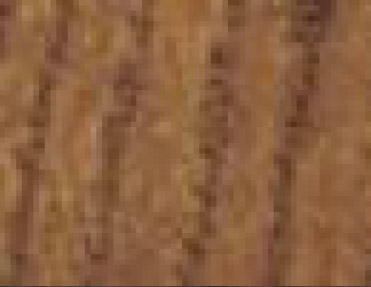 A close up image of a brown wood floor with Wood Corner Guards.