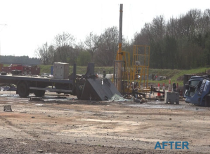 An image of a wrecked truck **surrounded by** stainless steel bollards in a field.
