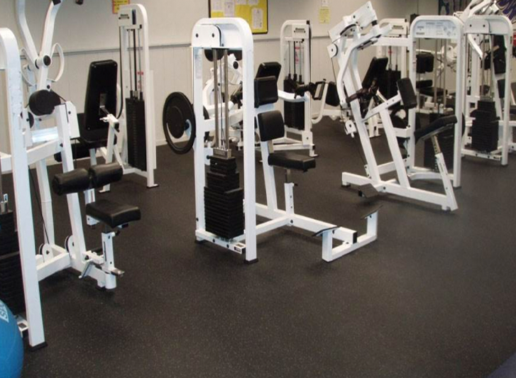 A gym with a variety of machines and weights, now offering anti fatigue mats and hollow mats for purchase.