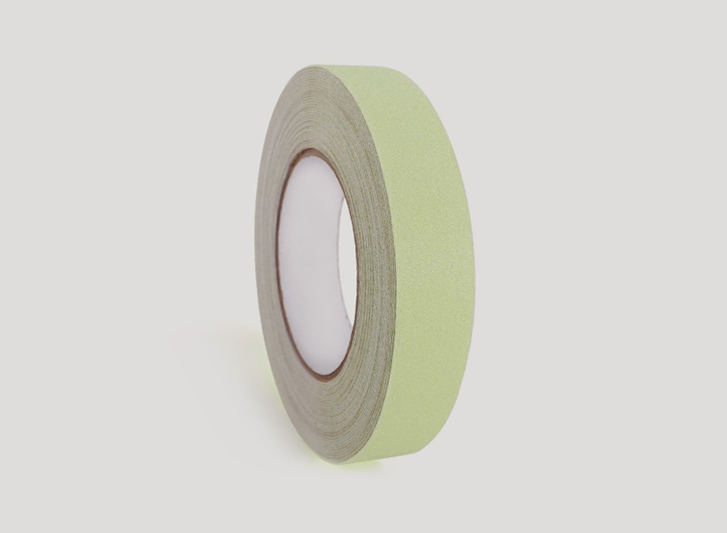 A roll of green antislip tape on a white background.