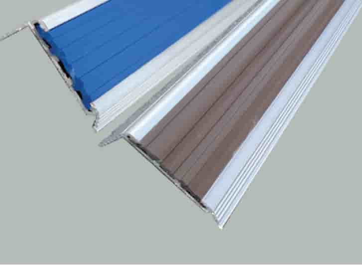 Two different types of aluminum gutters on a gray background.