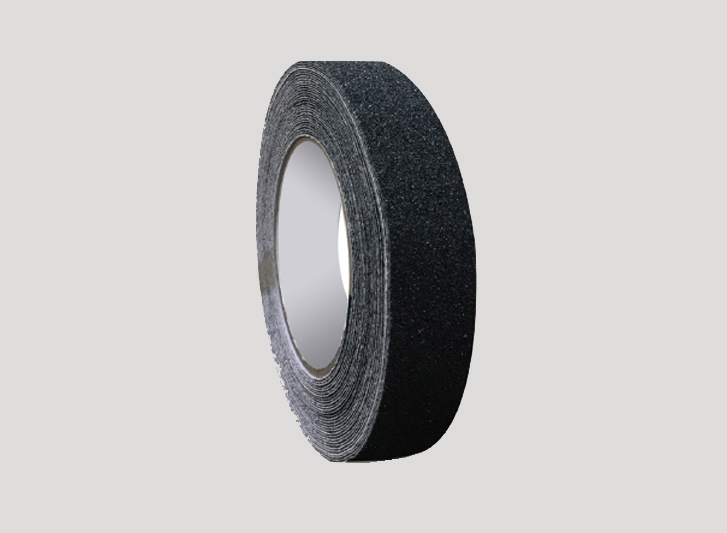 A roll of black antislip tape on a white background.