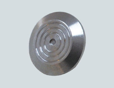A circular metal disc on a white background.