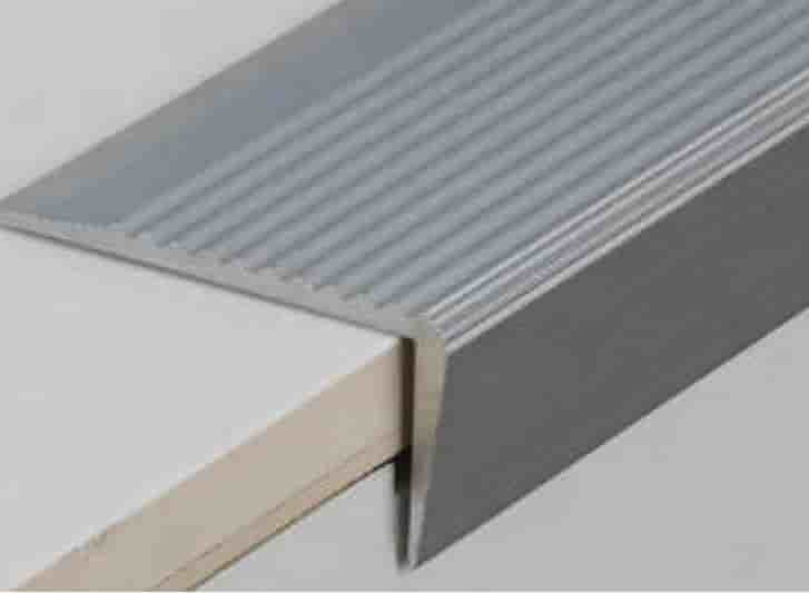 A metal stair edging with a piece of wood featuring aluminium stair nosing.