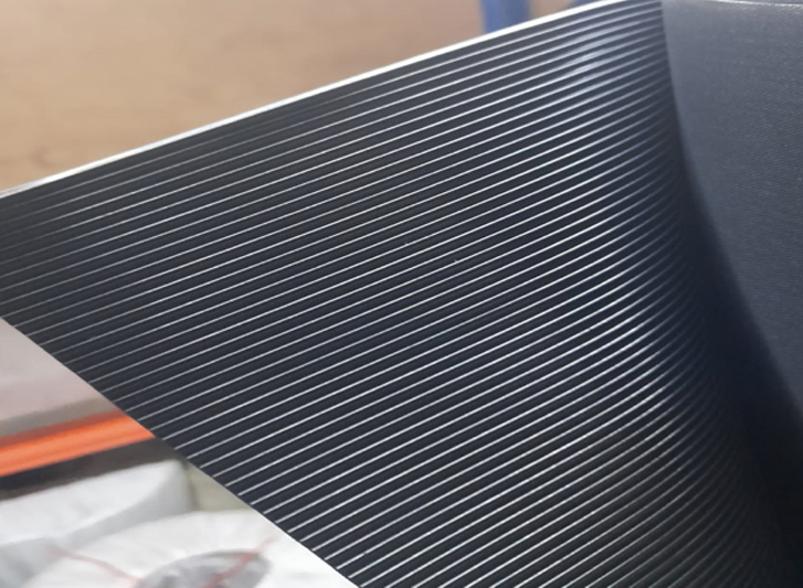 A close up of a black sheet of plastic, ideal for buyers looking to purchase anti-fatigue mats or hollow mats.