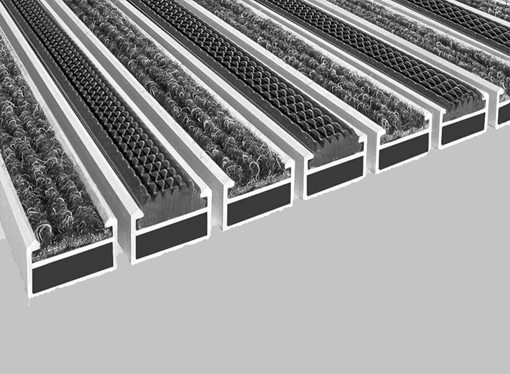 A series of black and white strips on a grey background featuring pvc entrance mats.