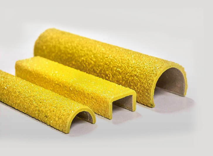 Three yellow plastic tubes on a white surface.