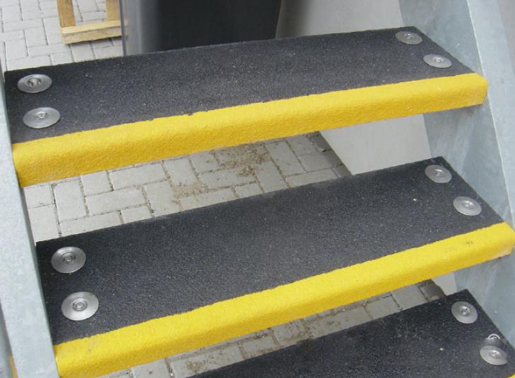 A set of stairs with black and yellow aluminium stair nosing.