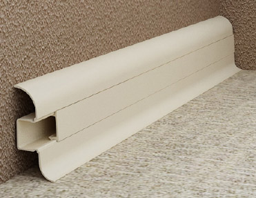 A white plastic rail on a carpeted floor, with pvc skirting.