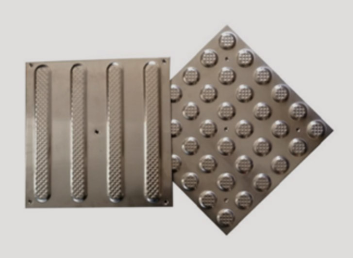 A metal tray with stainless steel road studs.