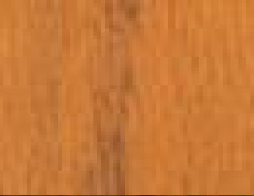 A close up image of a wooden floor with Wood Corner Guards.