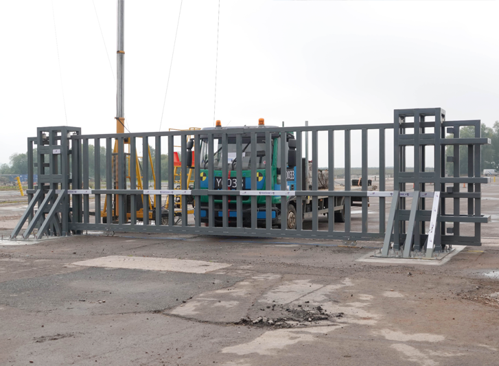 A truck is parked next to a stainless steel bollard.