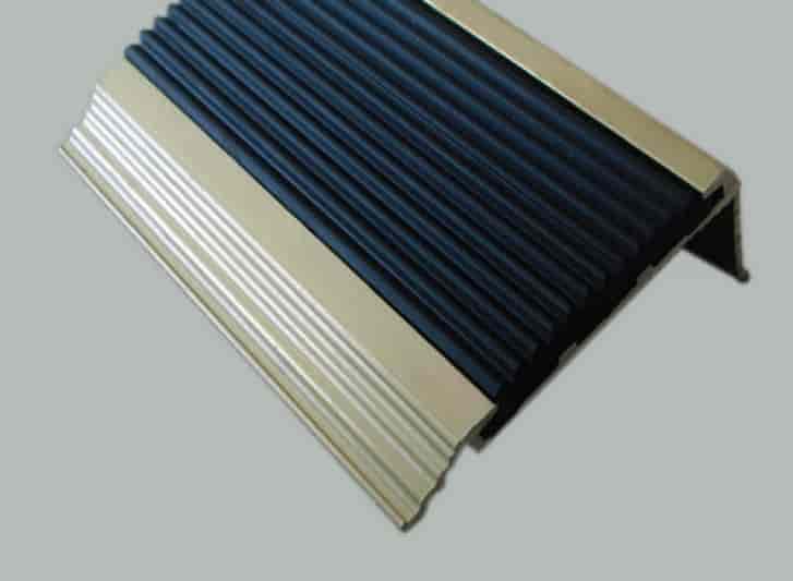 A gold stair tread on a gray background.
