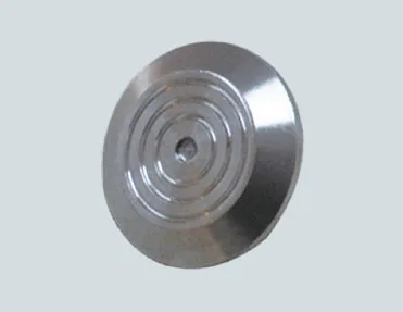 A circular metal disc on a white background.