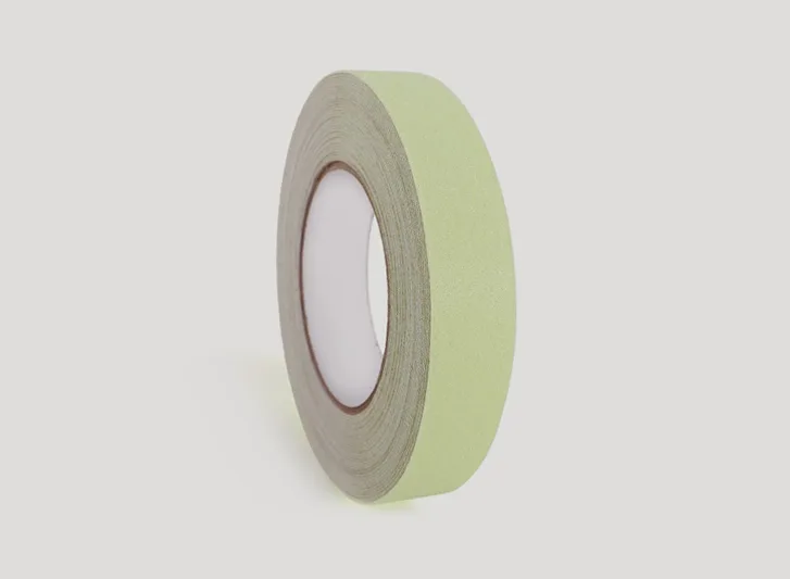 A roll of green antislip tape on a white background.