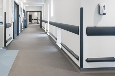 Hospital corridor with black wall guards and corner protectors
